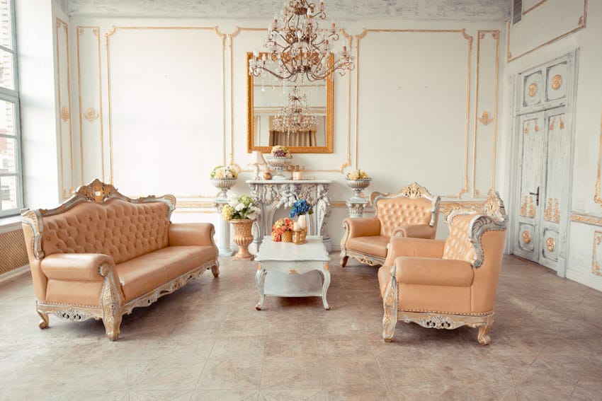 Luxury living room with regency style sofas, chairs, coffee table, mirror, chandelier, and windows