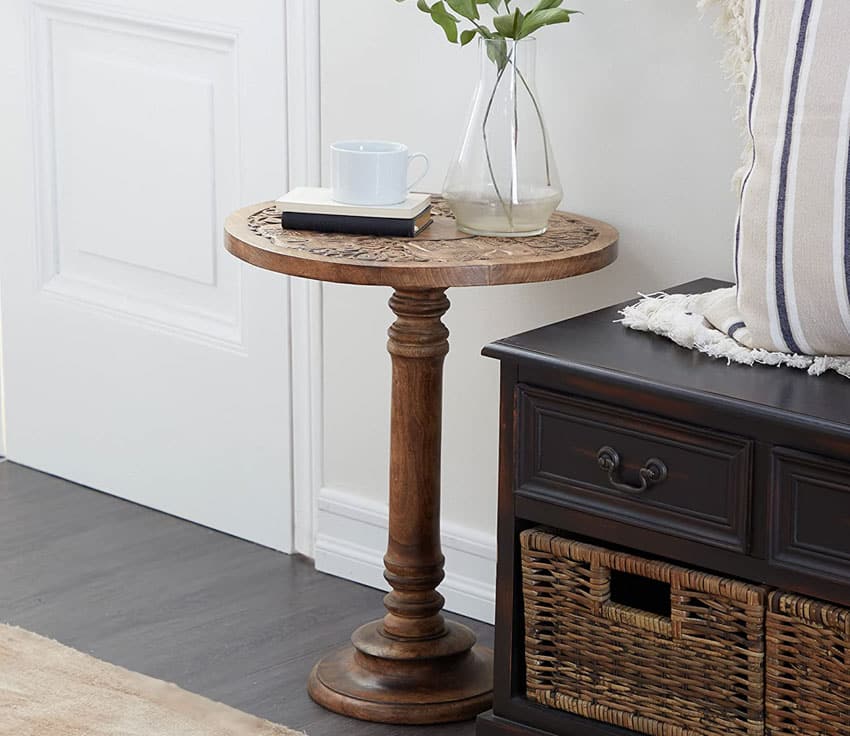 Wood accent table with embossed top and glass vase