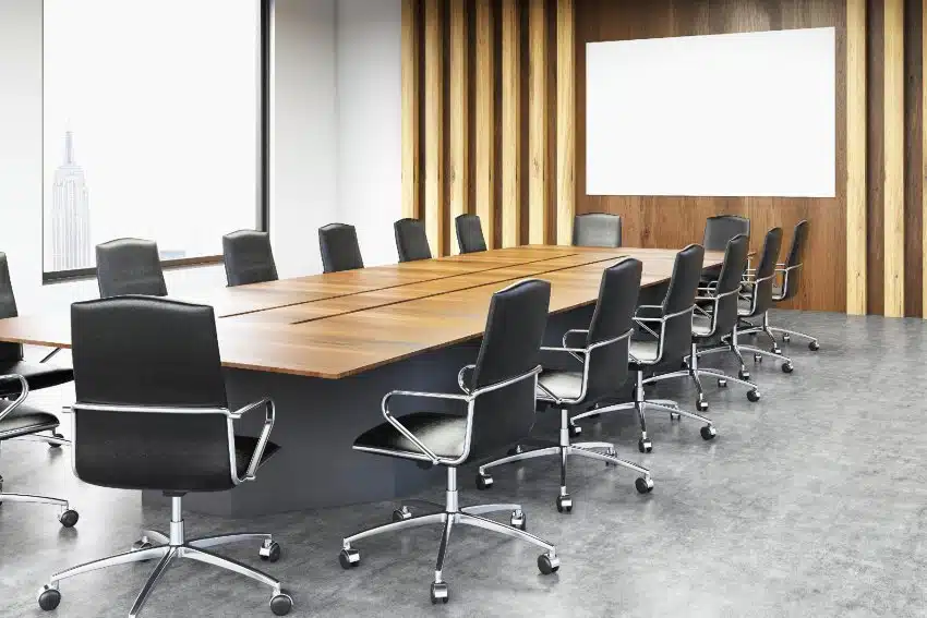 Modern conference room interior with blank whiteboard, conference chairs and table, wooden wall ceiling, concrete floor and window