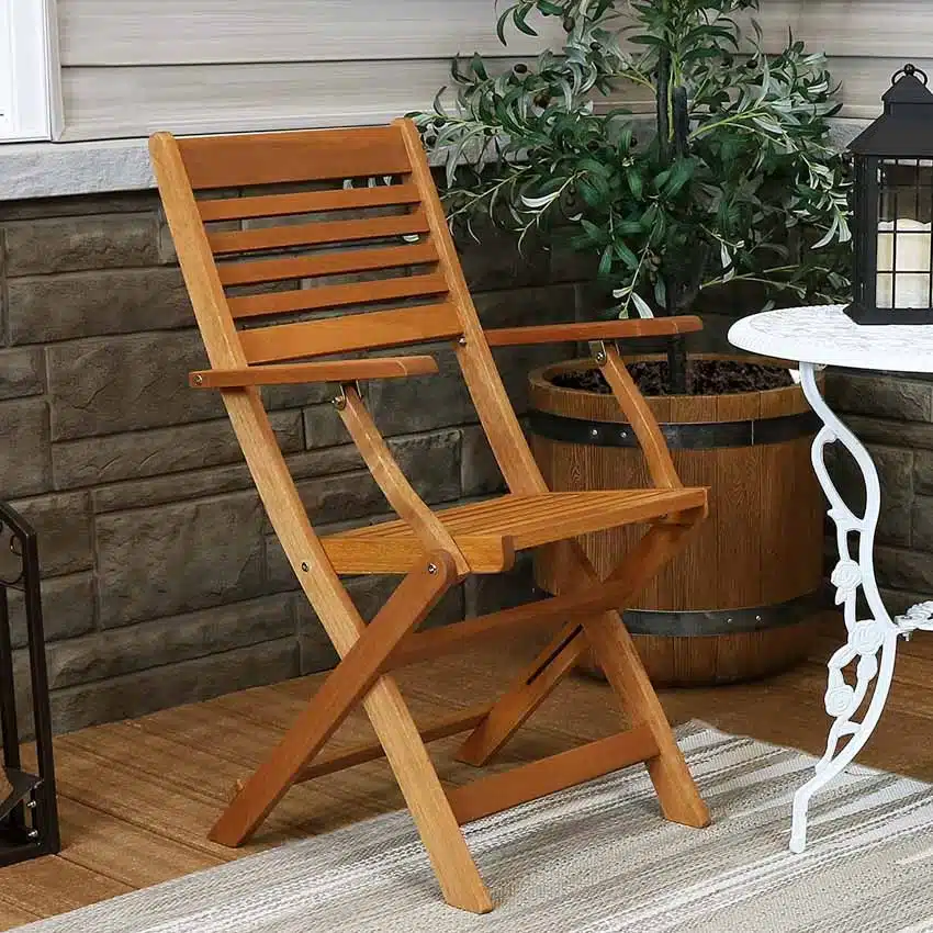 Outdoor marandi wood chair for patios with potted plants and side table
