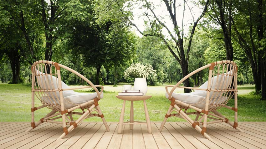 Patio with wicker outdoor chairs, wood deck, and side table