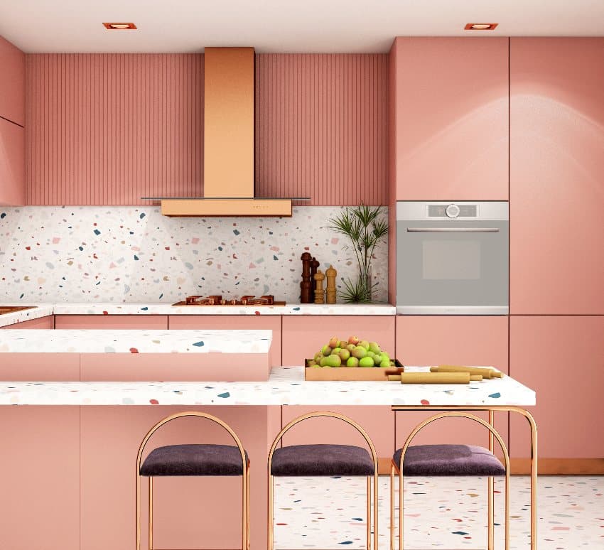 Peach modern kitchen inetrior with gold fixtures and terrazzo countertops, backsplash and floor