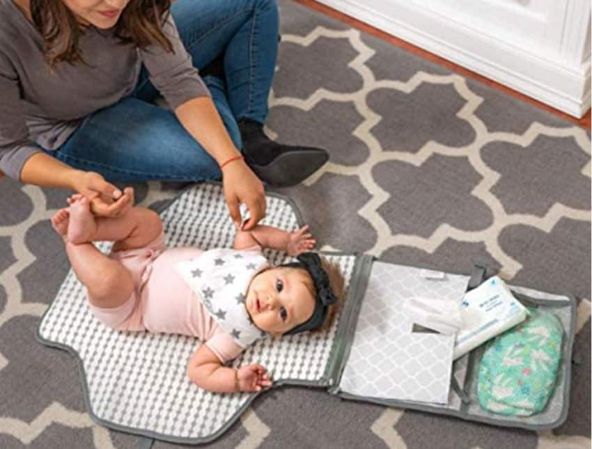 Portable changing station to help change diapers of baby