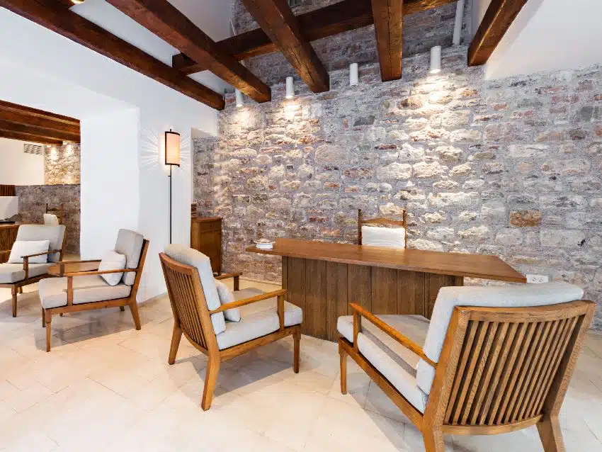 Waiting room with wood beams, brick walls and Stickley chairs