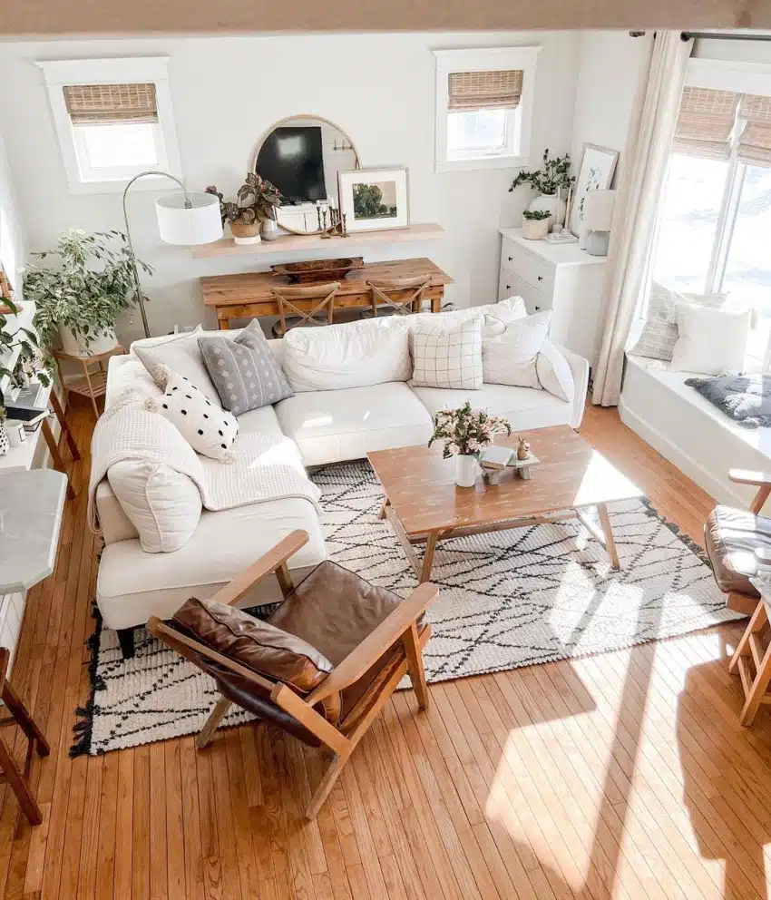 Living room with white sofa, wood plank floors and window seat