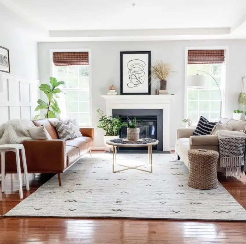 Living room with leather and fabric sofas, white mantel fireplace