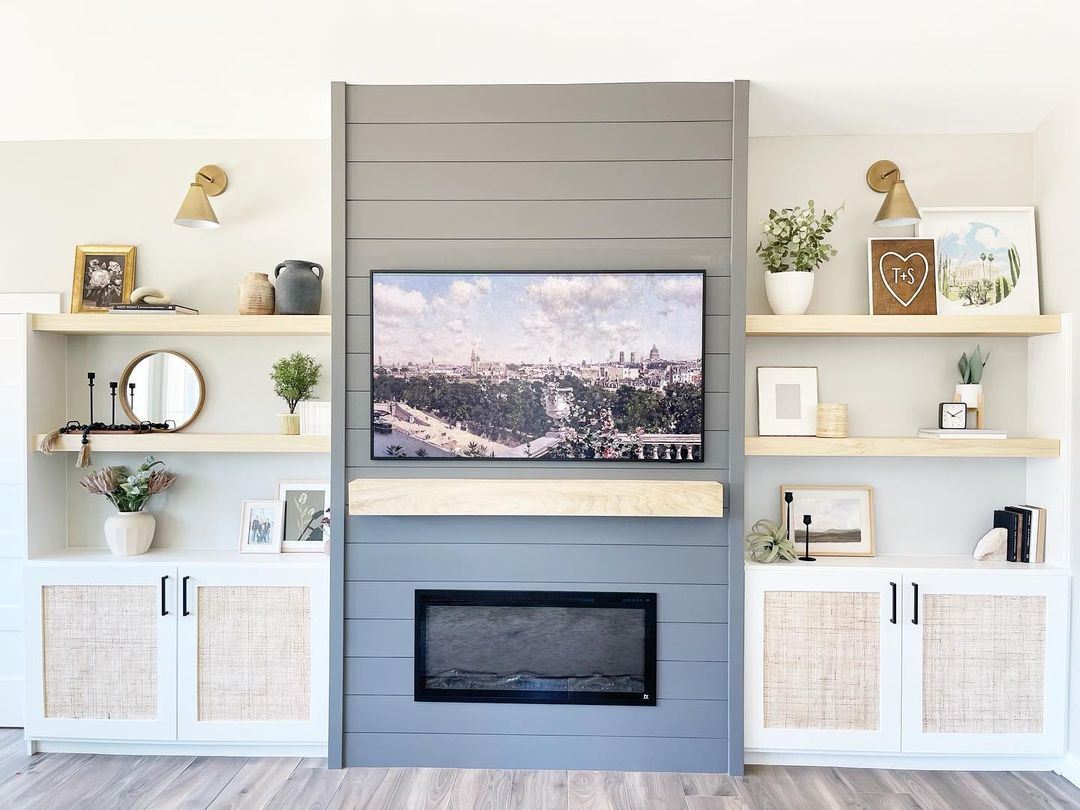 Living room with grey shiplap fireplace and built-in storage