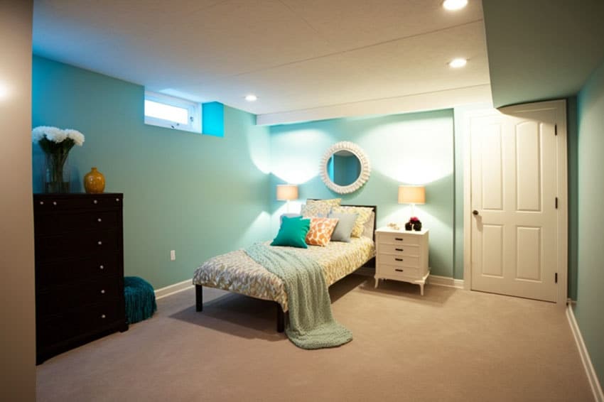 Basement bedroom with stylish aqua colored walls