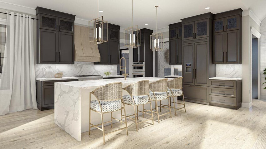 Coastal American house interior kitchen with island, chairs, wood cabinets, and marble backsplash