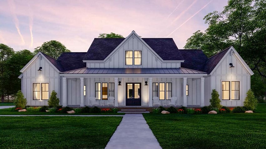 Modern farmhouse exterior at night with dormer, board and batten siding, and porch