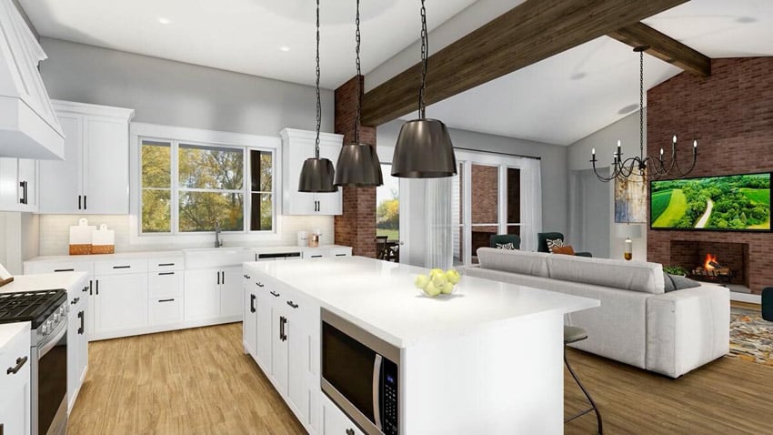 Modern farmhouse interior with kitchen island, fireplace, sofa, pendant lights, and cabinets