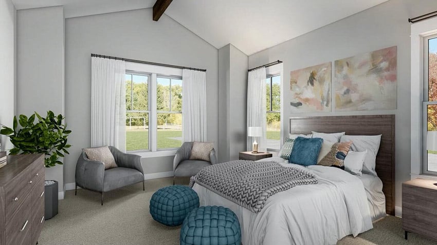 Modern farmhouse master bedroom with armchairs, comforter, and dresser