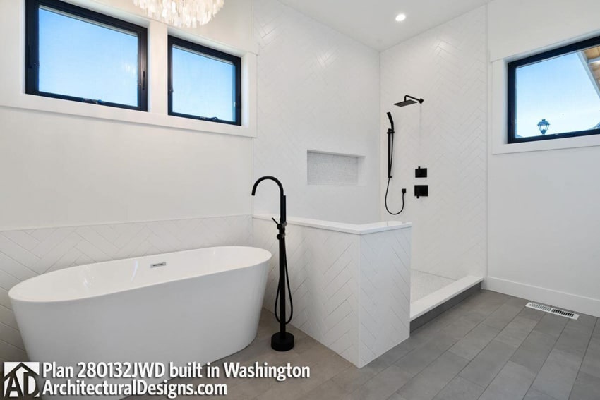 Farmhouse bathroom with tile flooring, herringbone tile backsplash, tub, and shower