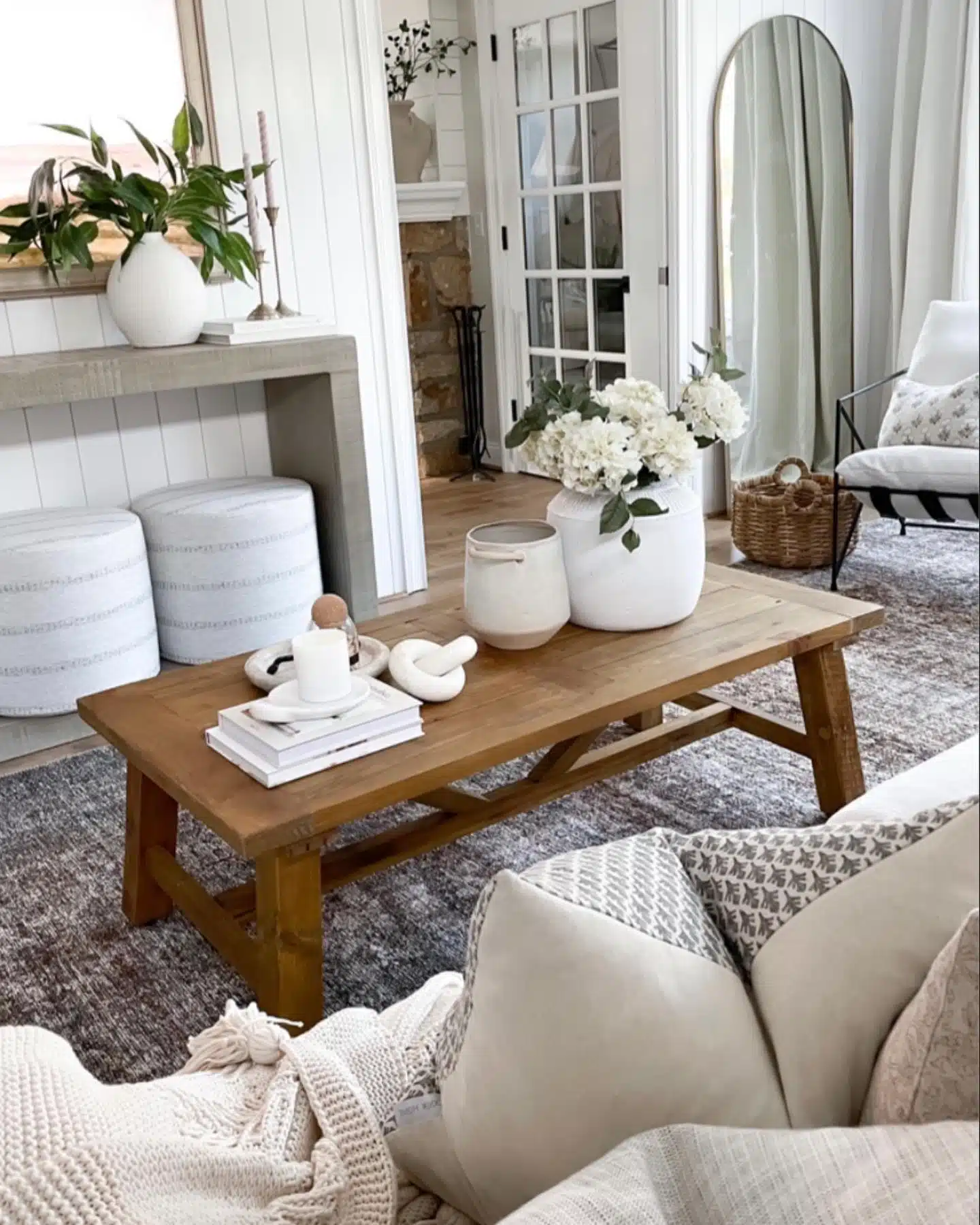 Modern farmhouse coffee table decor with console table and poufs