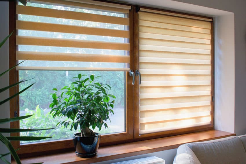 Basement windows with wooden frames handles and shades