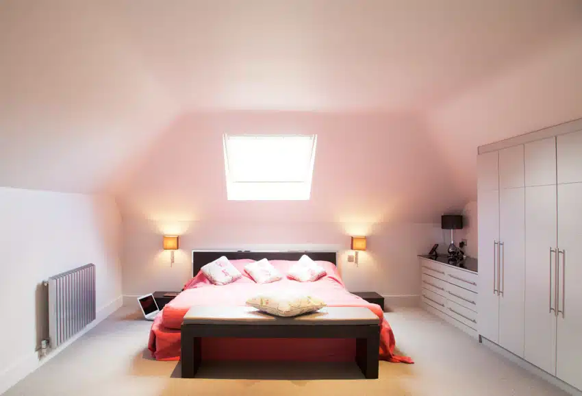 Bedroom with light pink walls, nightstands, wardrobe, and lamp