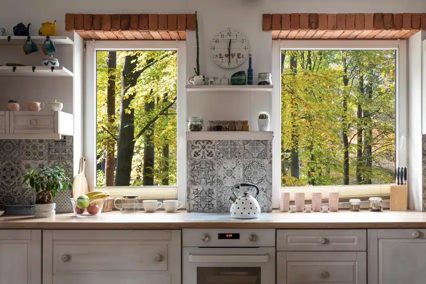 Kitchen with pattern tile backsplash, wood countertop, and floating shelves