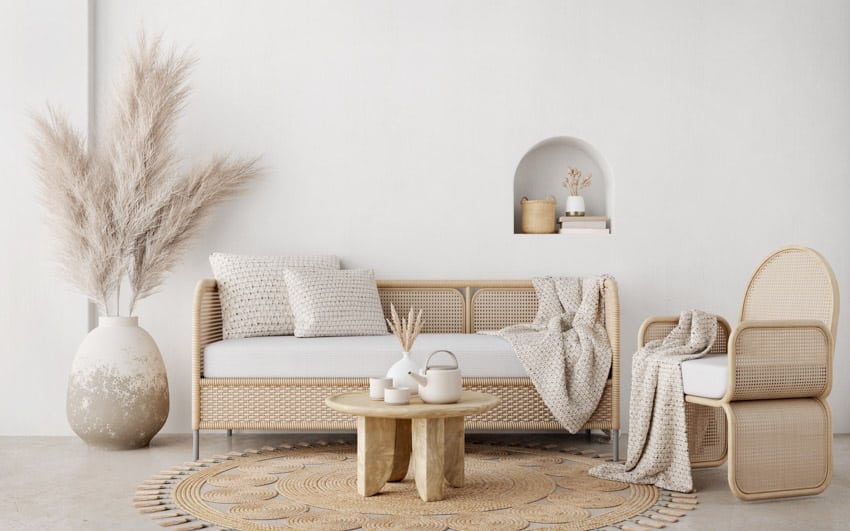 Bohemian living room with coffee table, floor vase, rug, sofa, and accent armchair