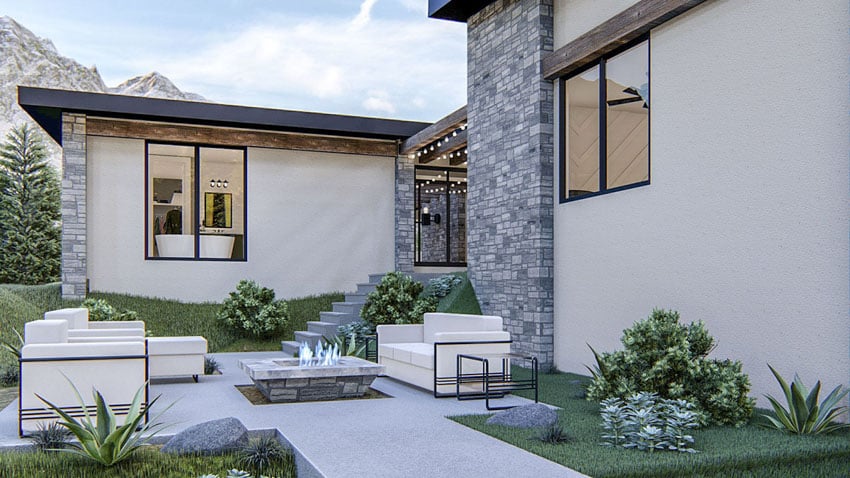 Exterior courtyard, stone wall cladding, sofa, and fire pit