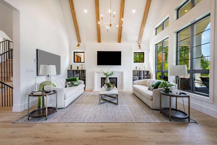 Exposed wood ceiling beams in expansive room with sofas facing each other