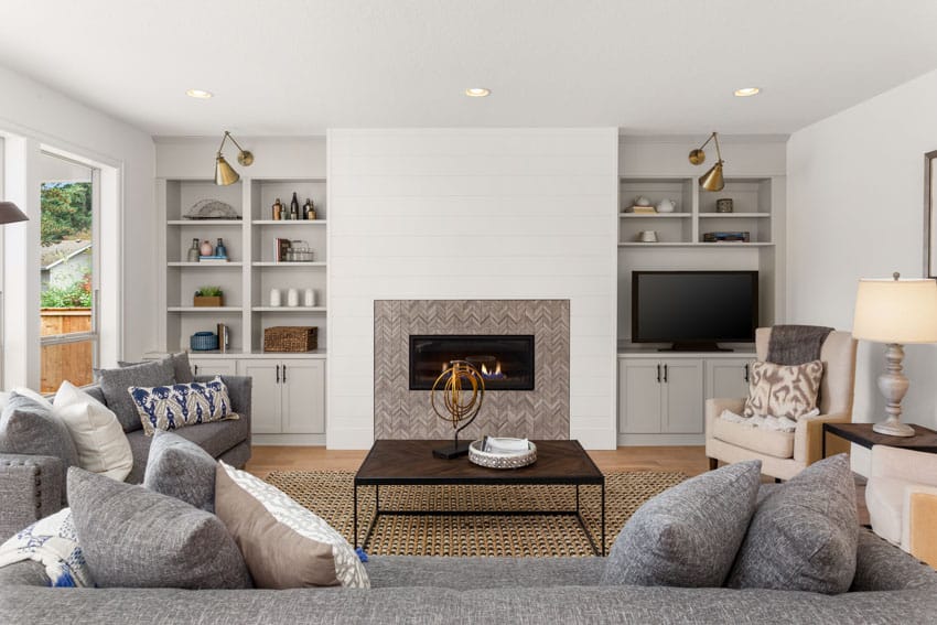 fireplace tile wall, built-in shelves, and sofa