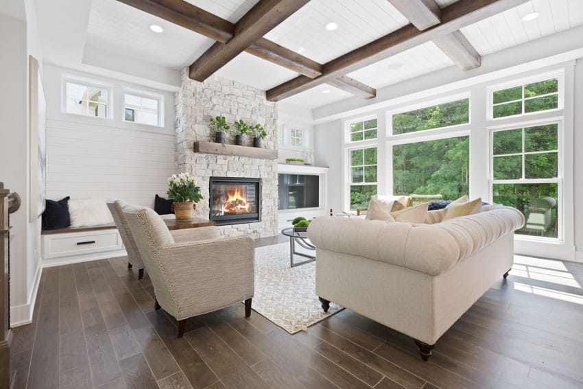 Gas insert unit fireplace, wood floating mantel, hardwood plank flooring, and coffered ceiling