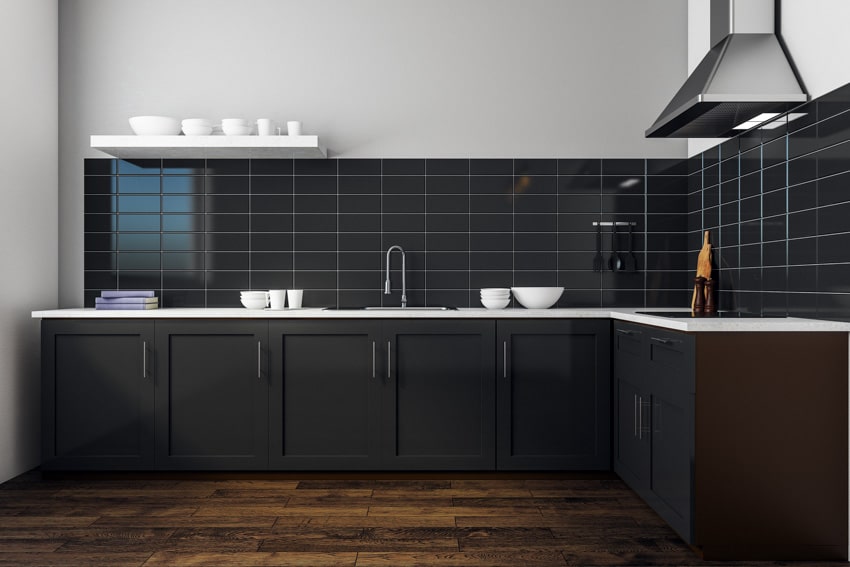 Kitchen with dark cabinets, and rectangular black tile backsplash