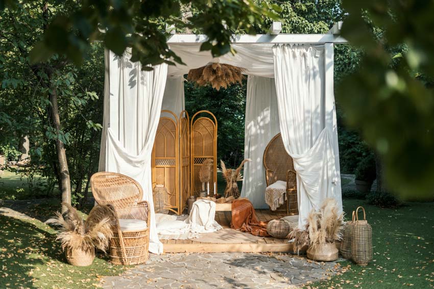 Outdoor area with furniture, divider, armchairs, and boho decor pieces