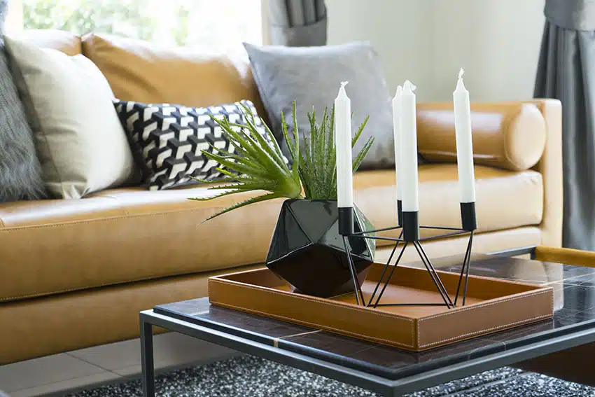 Coffee table with leather tray modern flower vase and taper candles