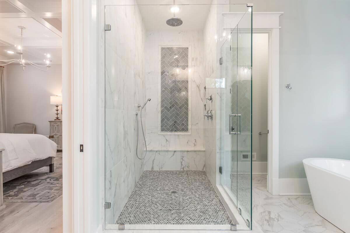 bathroom with shower tub and glass divider