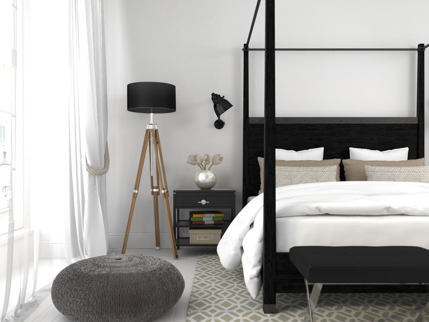 black and white bedroom with nightstand floor lamp and curtains