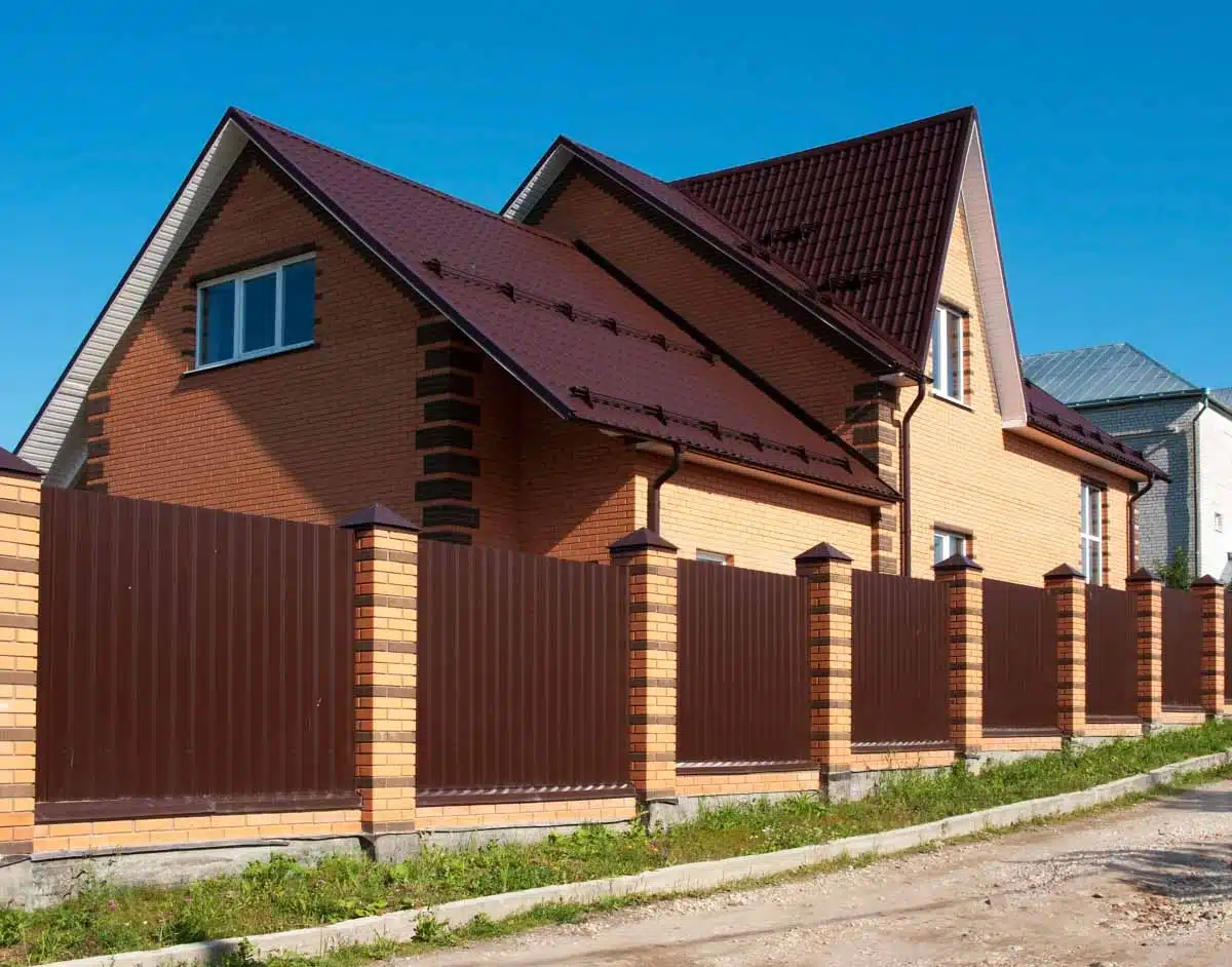brick house with brown fence