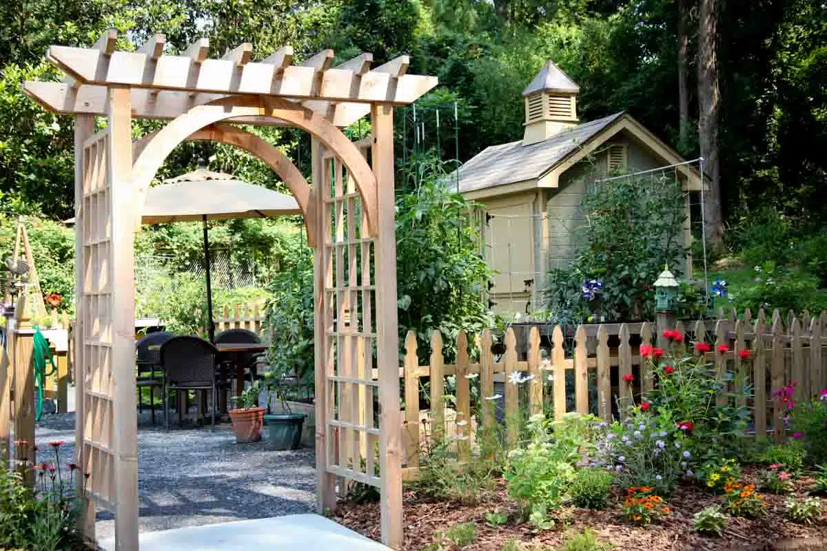 garden area with fence walkway and pergola