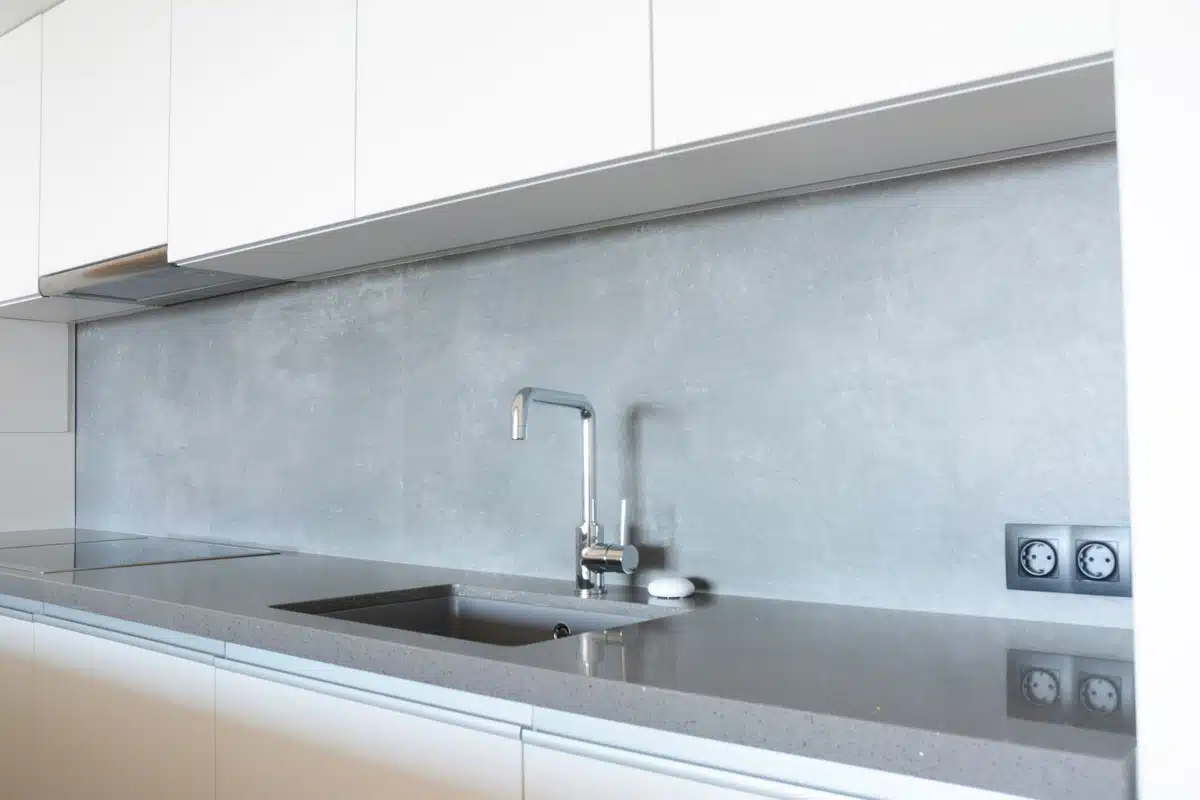 gray backsplash in kitchen with cabinets