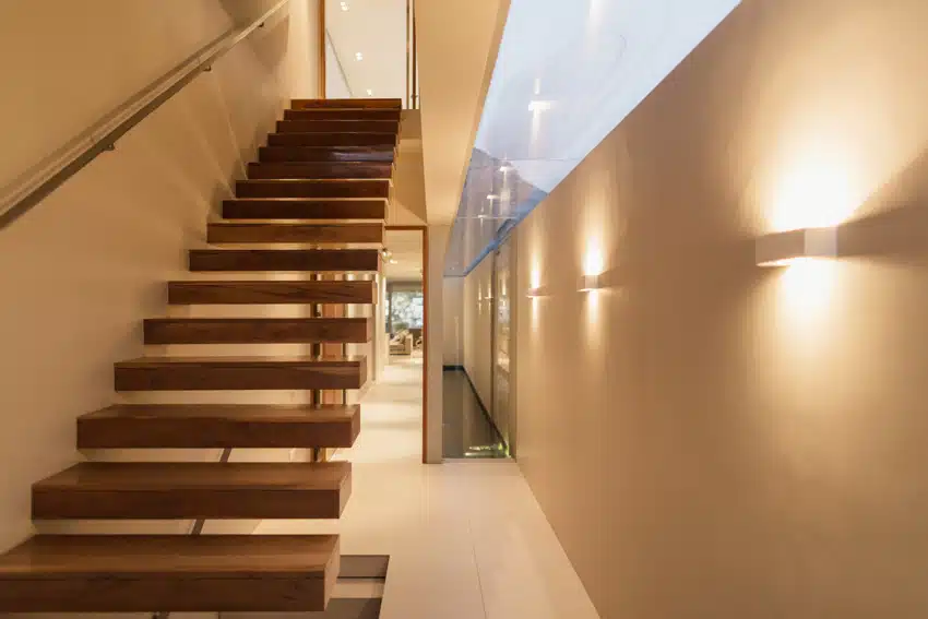 hallway with staircase and wall lights