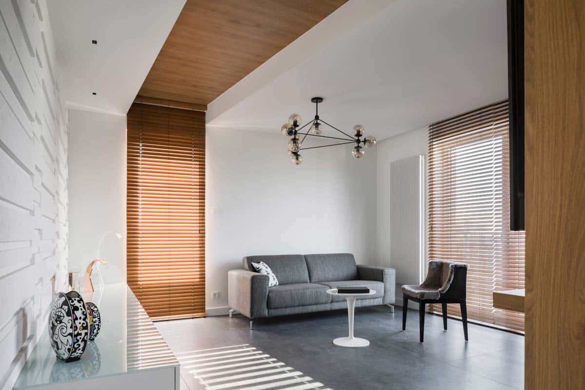 living area with sofa and wooden blinds