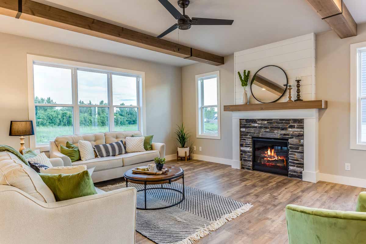 modern farmhouse area with fireplace and ceiling fan