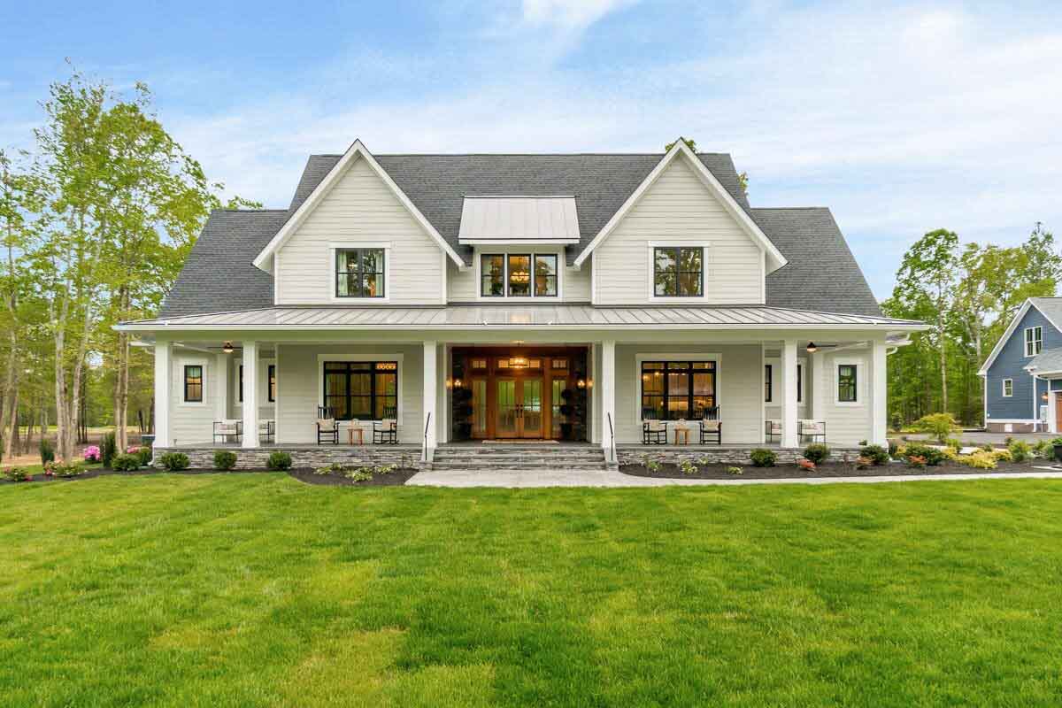 modern farmhouse with dormers front porch and front lawn