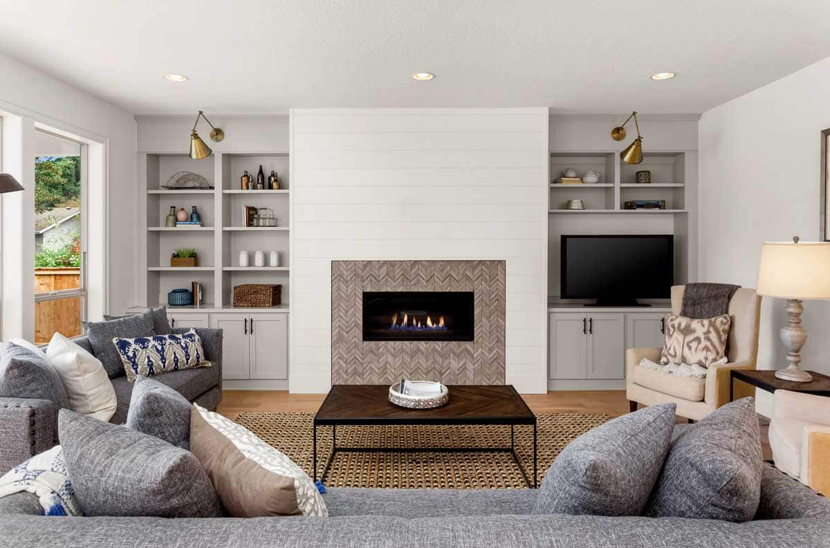 modern styled farmhouse room with fireplace and shelves