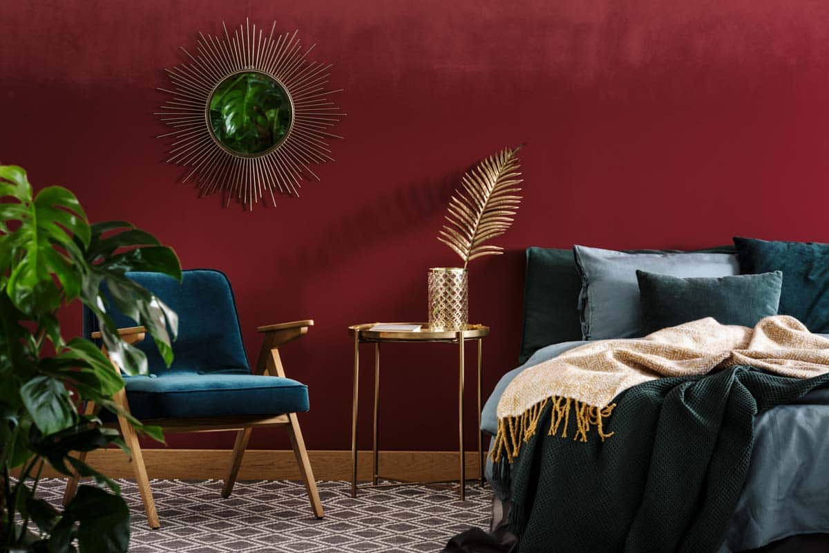 red bedroom with green and gold furniture