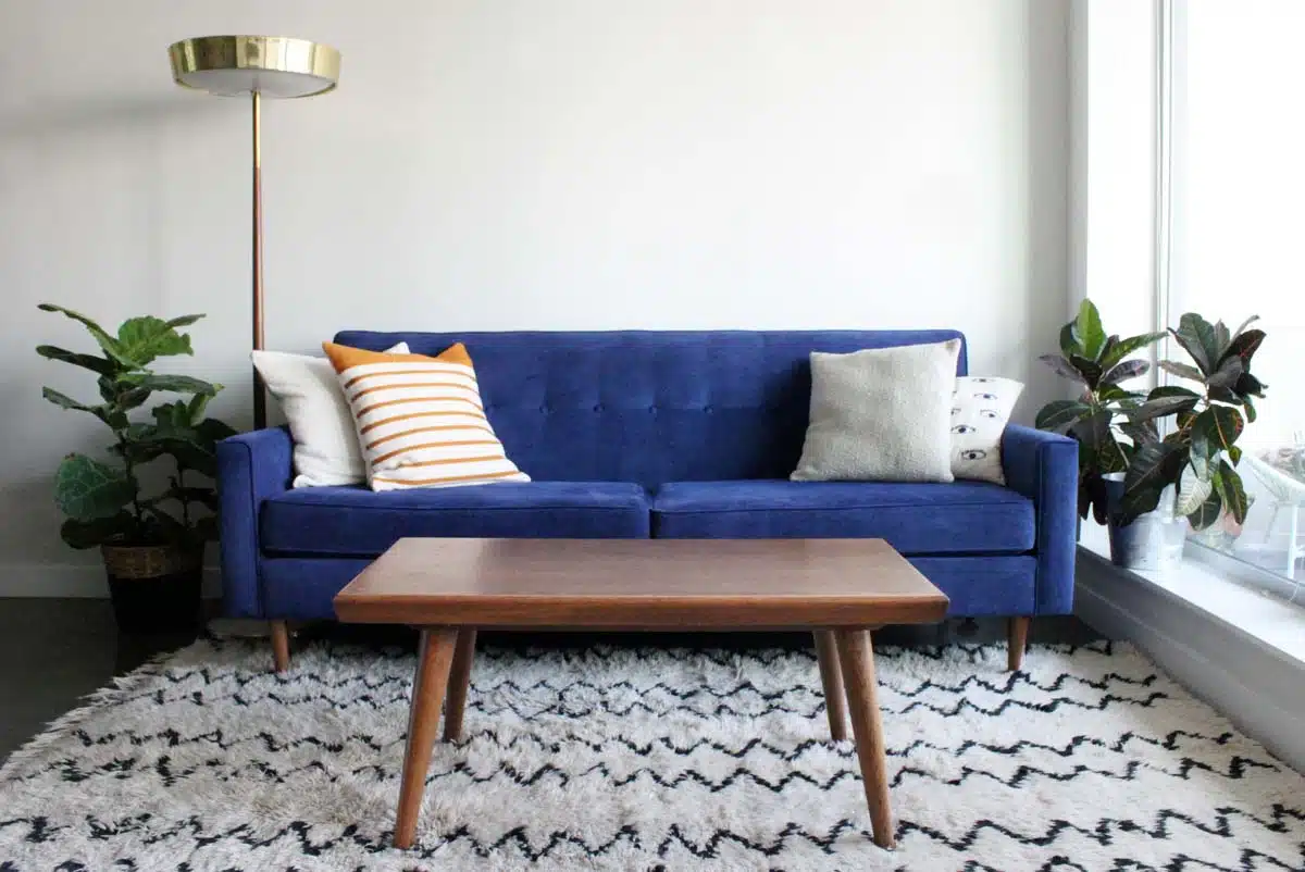 room with blue couch table and rug
