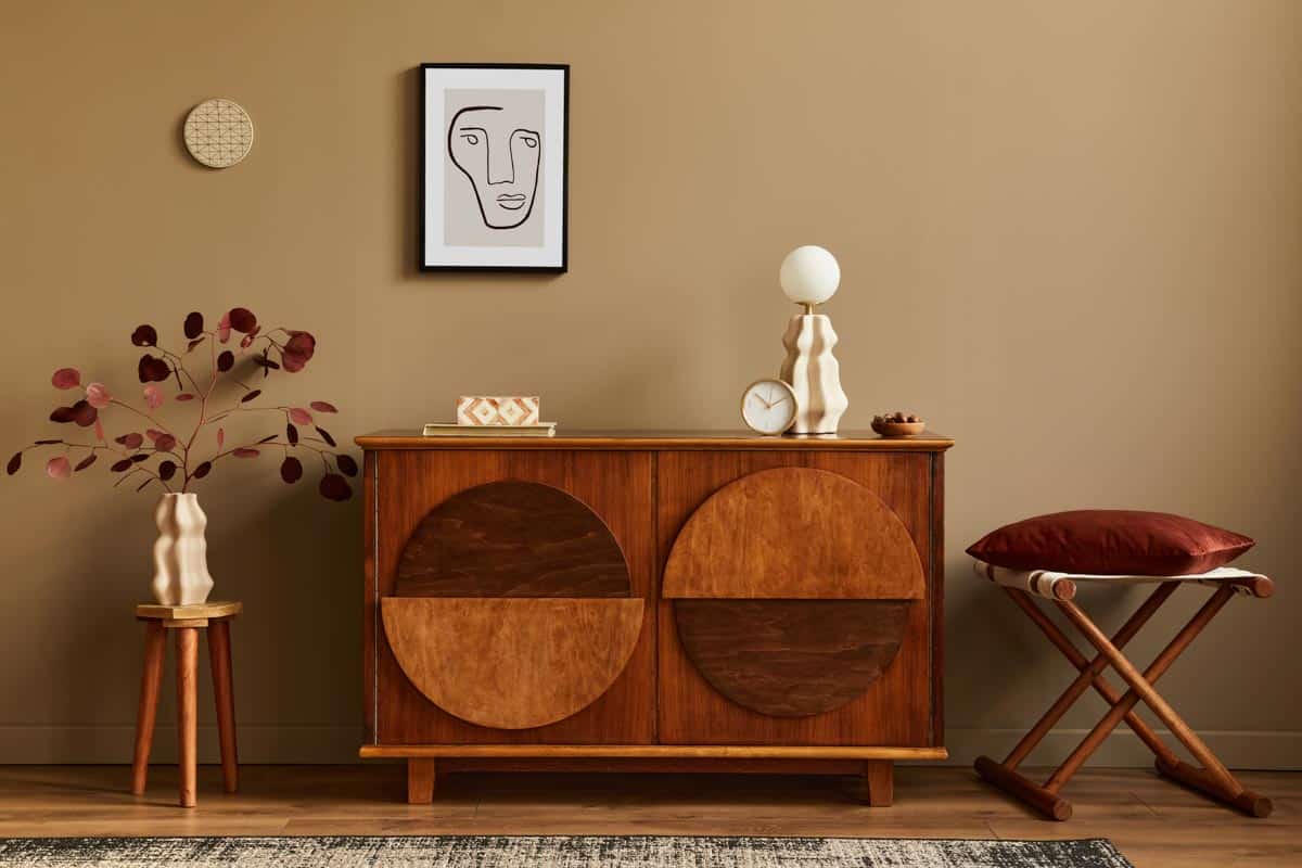 room with brown walls and dresser