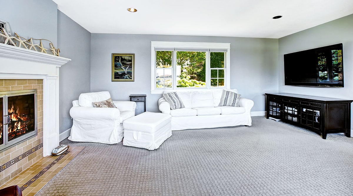 Carpeted floor with gray paint fireplace and credenza