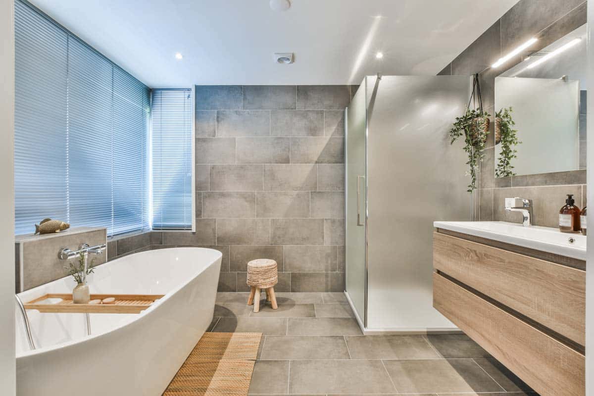 bathroom with tub shower windows and mirror