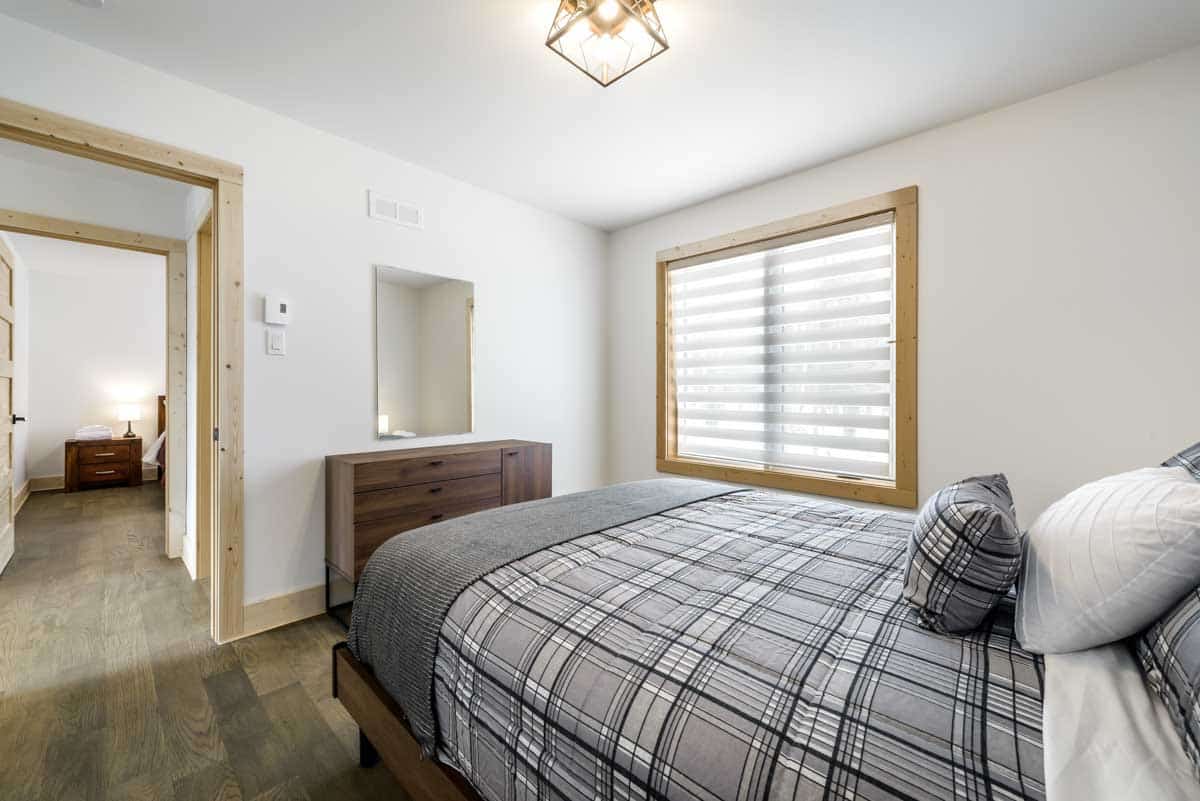 bedroom with dresser wood floor and window