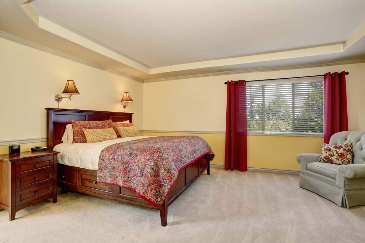 bedroom with red curtain and nightstand