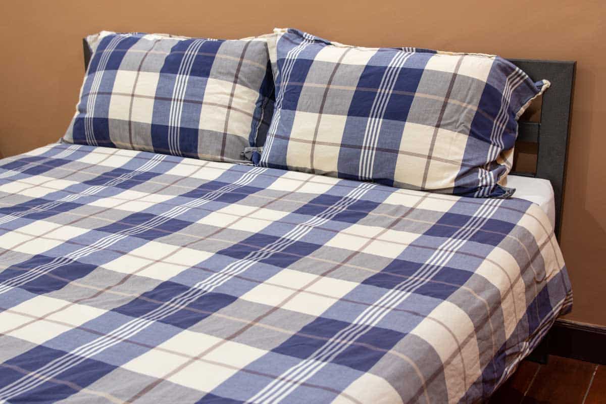 Blue and white patterned bed and pillows