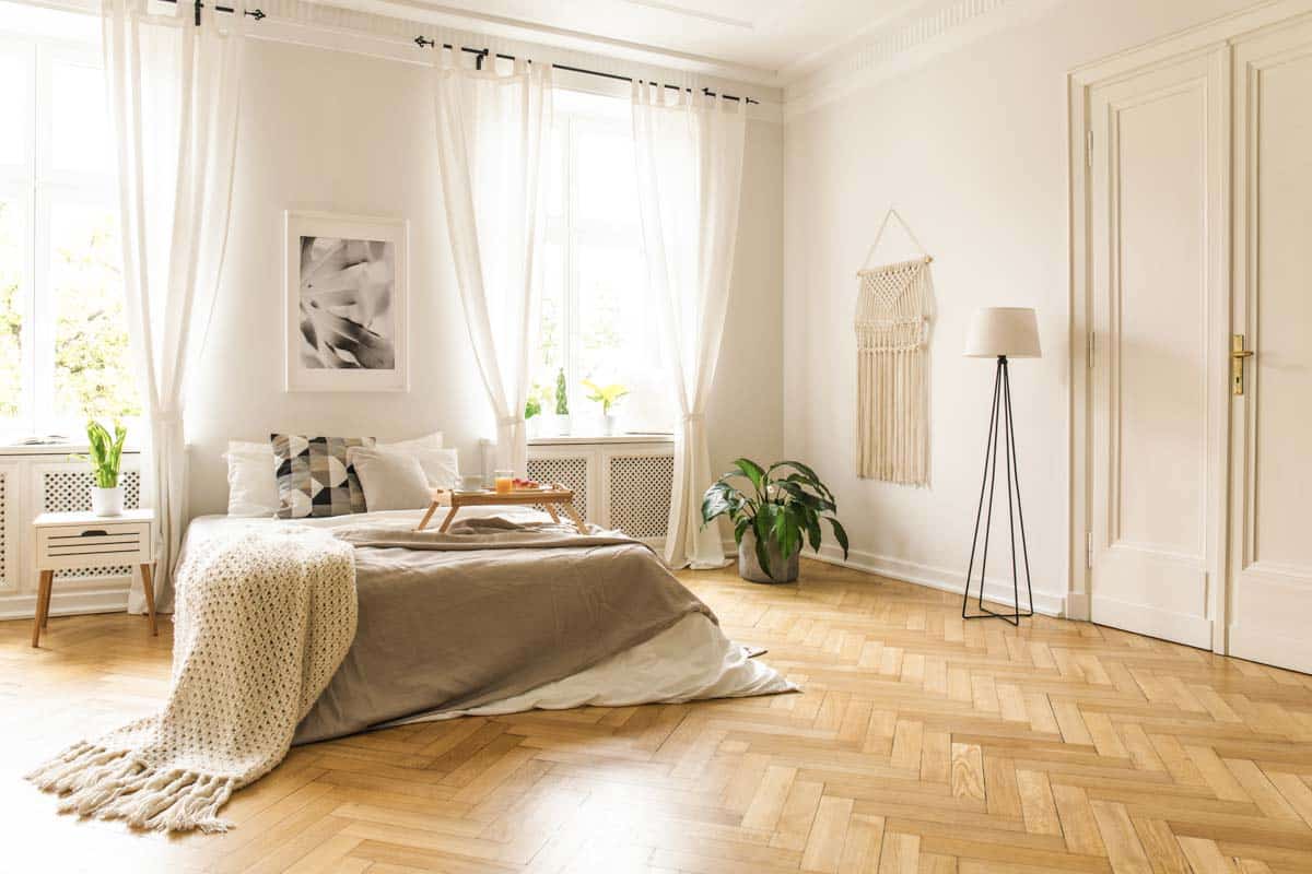 minimalist bedroom with wood floor and curtains