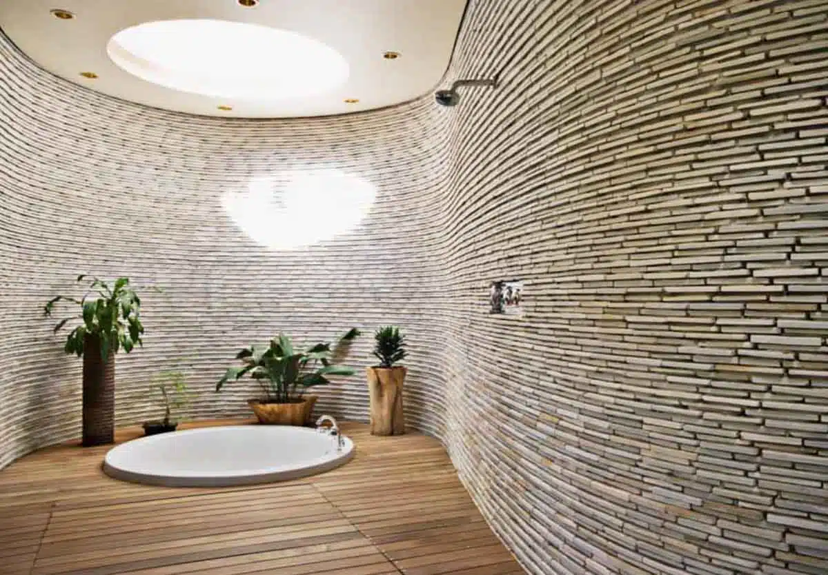 modern bathroom skylight accent wall tub wood floor indoor plant