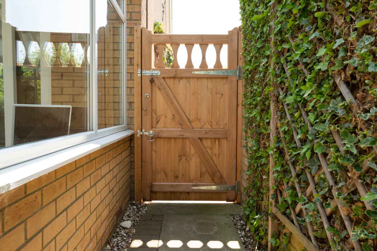 outdoor area with wooden gate and latch